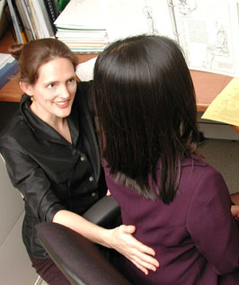 Ergonomics trainer Hilary Bryan coaches a client in dynamic alignment for the computer workstation. Photo by Steve Piaseki